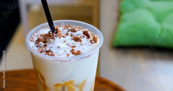 Obraz Velvety cream swirling over cold coffee, dusted with chocolate cookie crumbles, highlighting luxurious summer drink experience