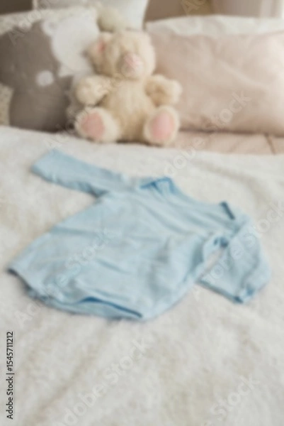 Obraz High angle view of clothing by stuffed toy on bed
