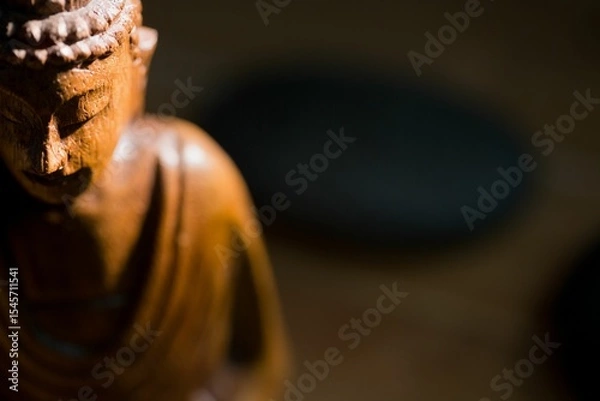 Obraz Close-up of Buddha statue by pebbles