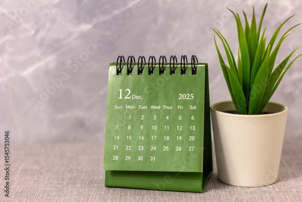 Fototapeta Hello, December 2025. Desktop calendar for planning on a gray background.