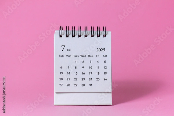 Fototapeta Hello, July 2025. Desktop calendar for planning on a pink background with copy space.
