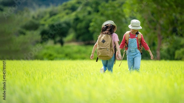 Fototapeta Group family children checking map in the jungle adventure.   Asia people tourism for destination leisure trips for education and relax in nature park.  Mountain background