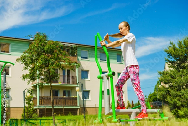 Fototapeta Girl exercise at outdoor gym area
