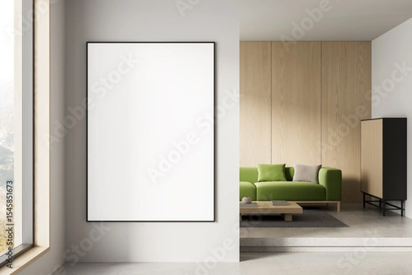 Fototapeta Blank poster mockup in modern interior with wooden panel wall and green sofa in clean minimalist living room layout for branding or design display. 3D Rendering