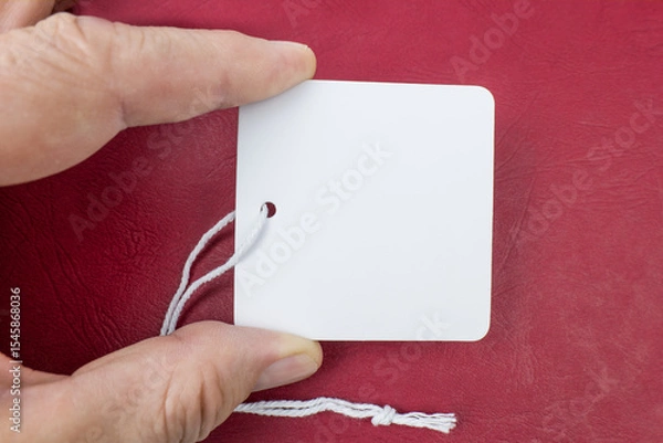 Fototapeta Blank Tag with a string on a red background