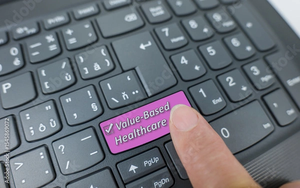 Fototapeta Value based healthcare key on a gray keyboard. Finger pressing key