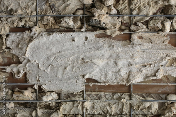 Fototapeta Background with elements of cement mortar scattered on a wall with a grid