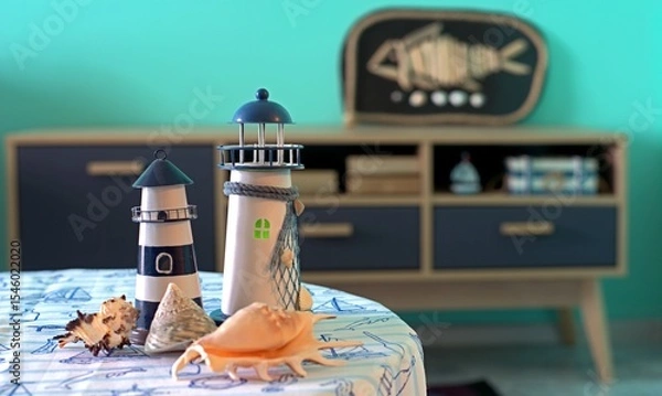 Fototapeta Lighthouses and shells on a table in a room decorated in a nautical style