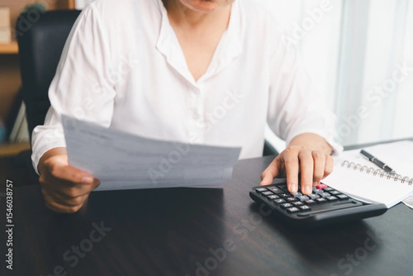 Obraz Using calculating machine, household carefully manages each bill and expense to plan financial budget, ensuring timely payment, consistent saving, smart investment for secure home finance strategy.