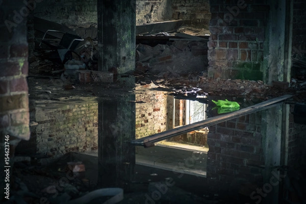 Fototapeta The view from an old, abandoned factory in inside with nice reflection and window light