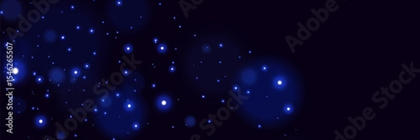 Obraz Blue glowing particles on dark background with soft bokeh light effect and dreamy cosmic atmosphere