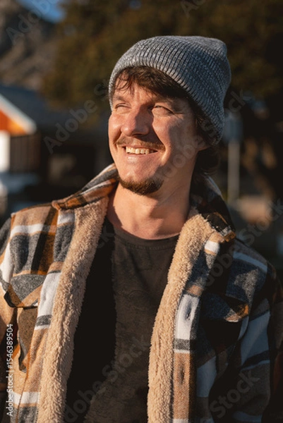 Fototapeta Happy Man in Plaid warm Shirt and Beanie in Suburban Setting