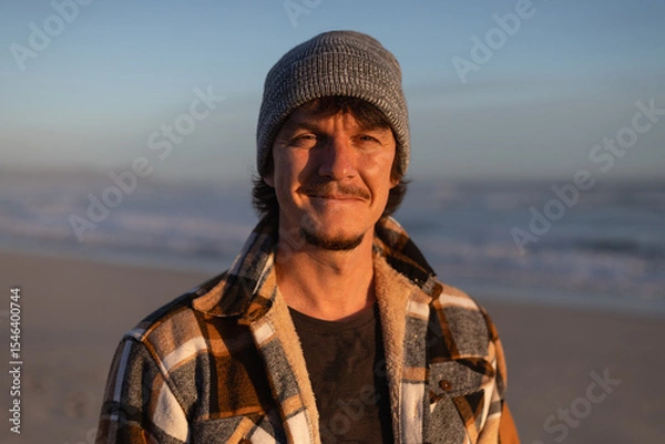 Fototapeta Happy Man in Warm Plaid Shirt and Beanie by the Ocean