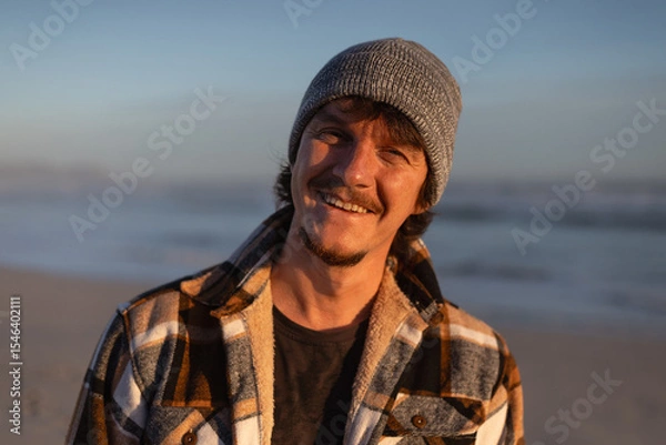 Fototapeta Happy Man in Warm Plaid Shirt and Beanie by the Ocean