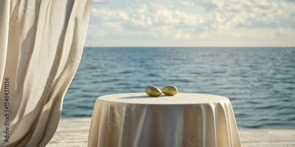 Fototapeta A serene coastal scene featuring a simple table adorned with a tablecloth and two limes, set against a tranquil ocean backdrop. Perfect for hospitality and lifestyle themes.