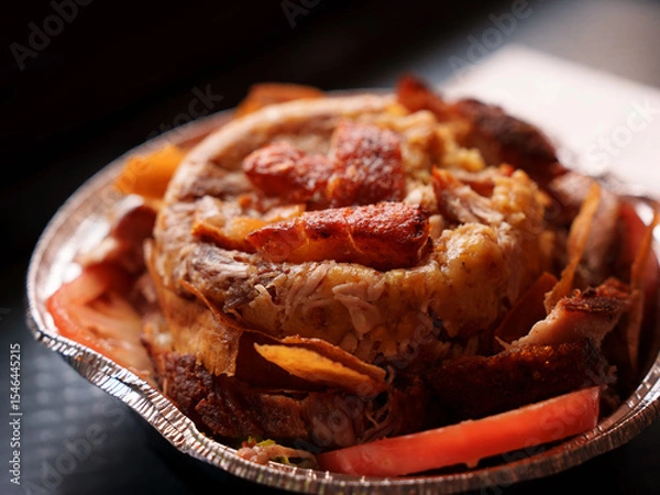 Fototapeta Close-up of a savory mofongo takeout plate, golden plantains mashed with garlic and chicharron