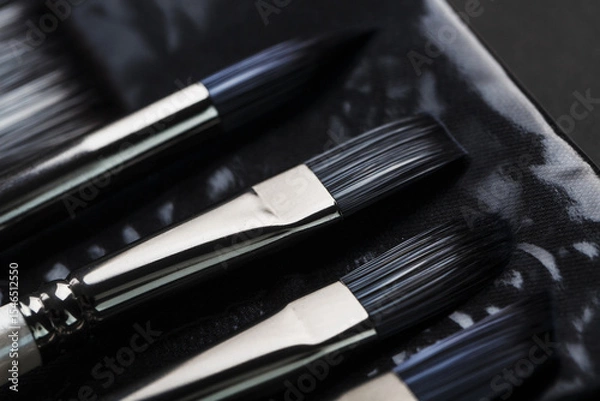 Fototapeta A set of oil brushes and palette knife isolated on a black background