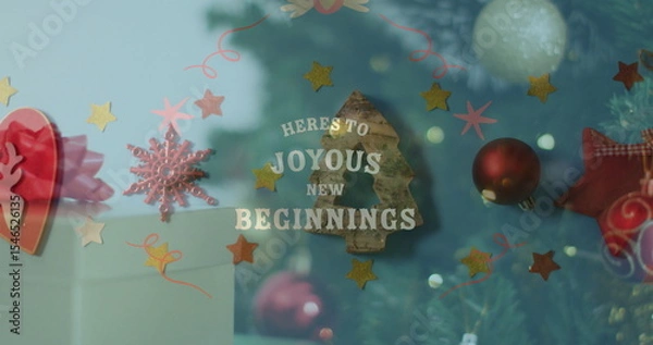 Fototapeta Showcasing lettering HERE'S TO JOYOUS NEW BEGINNINGS in shop window, with stars and tree silhouette