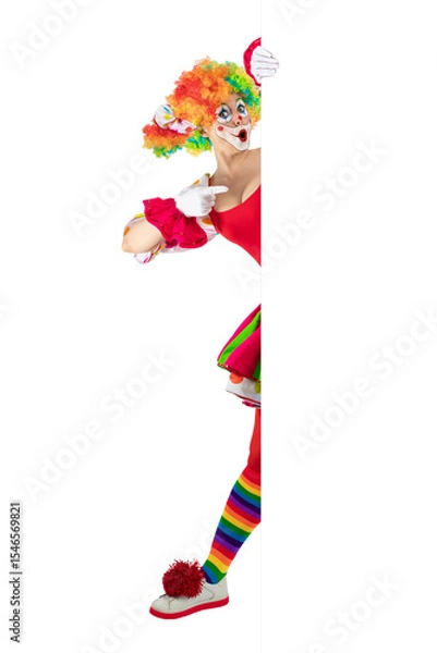 Fototapeta Funny surprised clown pointing sign blank template mock up for advertising, posters, greetings, invitations. Entertainer as Joker in a suit and wig, with clown whiteface makeup.