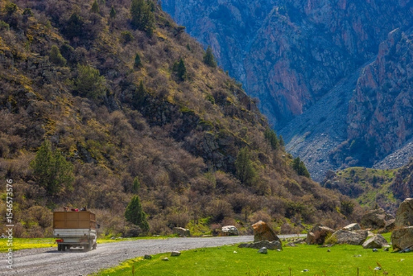 Obraz Truck transporting horses in mountainous region of Kyrgyzstan during daytime