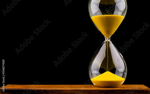 Obraz Hourglass stops time of work and life. Process and rules of limited time. Hourglass photo in studio.