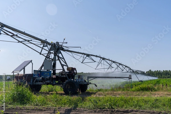 Fototapeta Autonomous machine is moving watering pivot along irrigation canal