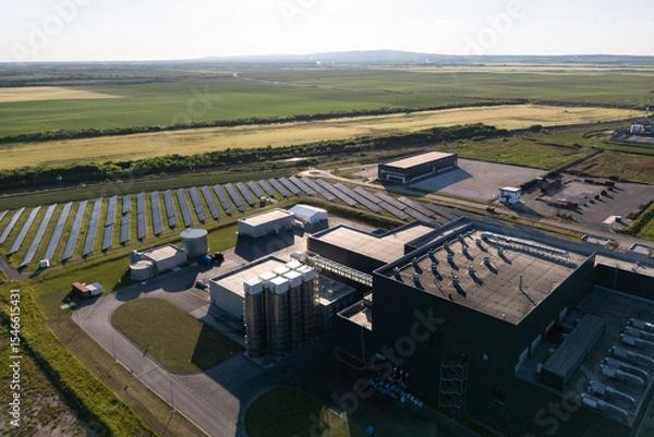 Fototapeta Modern green factory powered by renewable solar energy. Sustainable development in industry