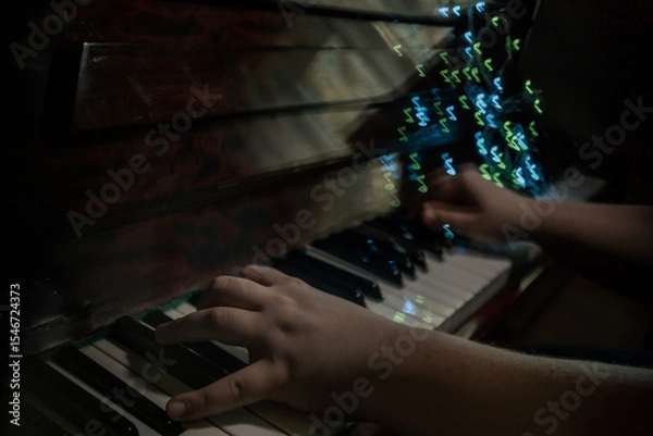 Fototapeta The piano player hands, playing music abstract photography with notes shaped bokeh 