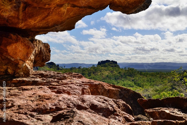Fototapeta View of the Chillagoe - Mungana Caves National Park, featuring towering limestone fins and jagged spires framed by blue sky, with dry bushland and red earth in the surrounding landscape