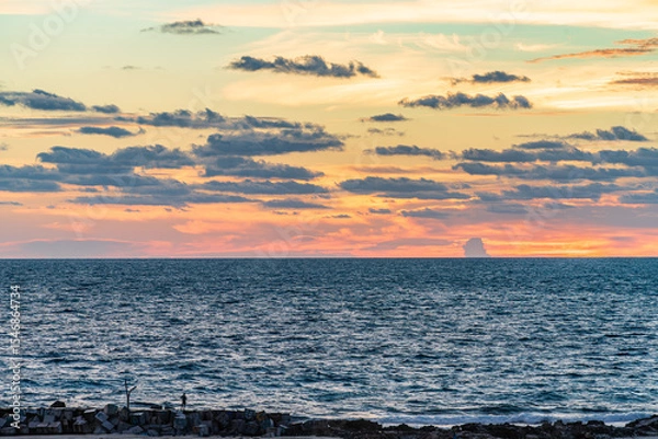 Fototapeta Stunning ocean view at sunset from Cancun Hotel Zone with dramatic clouds and glowing colors over the horizon High-quality photo