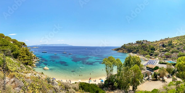 Fototapeta View to Cannelle beach, Spiaggia delle Cannelle, near Giglio Porto with view to mediterranean sea and beautiful blue bay at Isola del Giglio, island of the tuscan archipelago, Grosseto Tuscany Italy