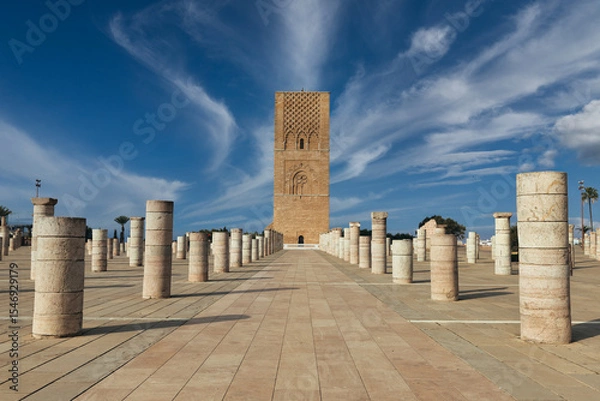 Fototapeta Ancient columns, mosque minaret, clear sky.