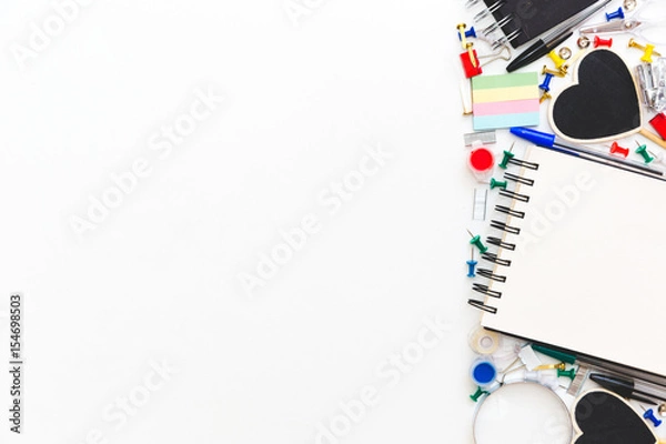 Fototapeta School and office stationery at white table. Flat lay with copy space.