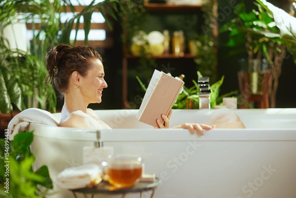 Obraz Woman Relaxing in Bubble Bath with Book