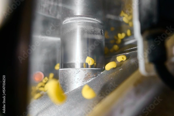 Fototapeta Pasta extrusion process creating shapes from dough in a factory setting