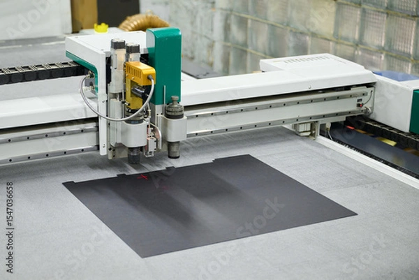 Fototapeta Precision cutting process using an industrial large-format CNC plotter for creative design work in a modern workshop setting