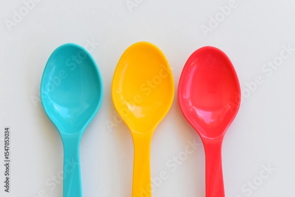 Fototapeta colorful spoon isolated on white background, plastic cutlery for picnic