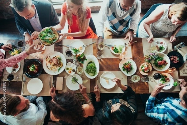 Fototapeta Diverse group dining together, sharing food, enjoying a meal. Mixed ethnicities, men and women, social gathering, vibrant table setting, communal dining experience. Celebration and gathering.