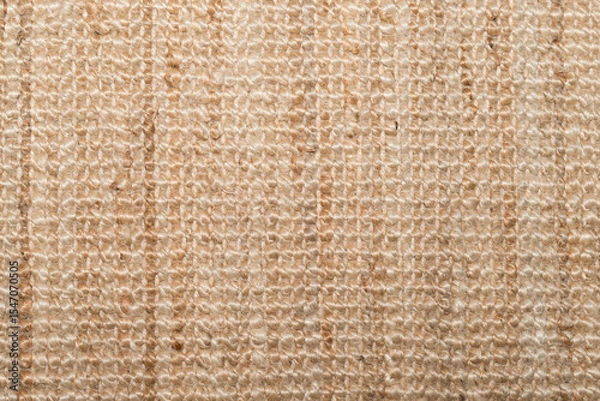 Fototapeta Overhead shot of a woven beige rug with visible fibers and subtle lines. Natural warm tones, ideal for backgrounds, texture overlays, or interior design mockups