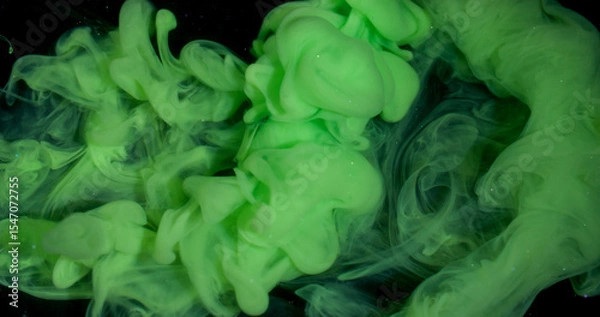 Fototapeta Smoke stream. Dye spread. Bright color green paint explosion flow. Art fume wave spray abstract blur black sparkling water background.