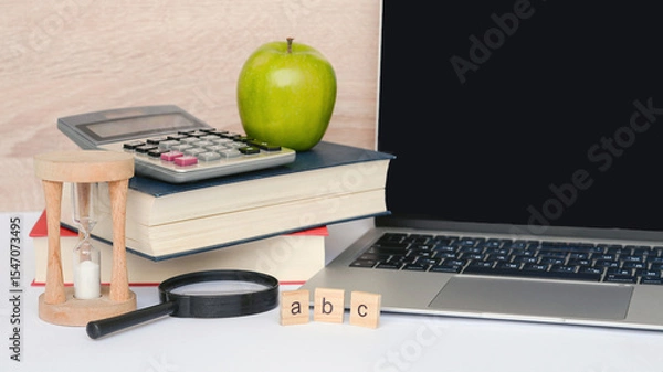 Fototapeta Essential items for studying effectively include books, a laptop, and various learning tools
