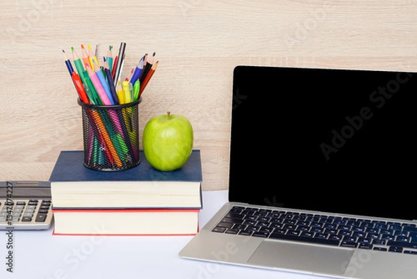 Fototapeta A Modern Study Workspace Featuring a Laptop, Various Books, and Creative Supply Items