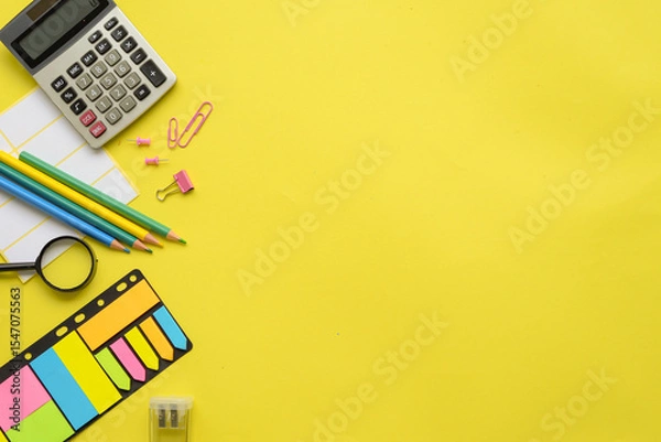 Fototapeta An Array of Colorful Office Supplies Laid Out on a Bright Yellow Background for Inspiration