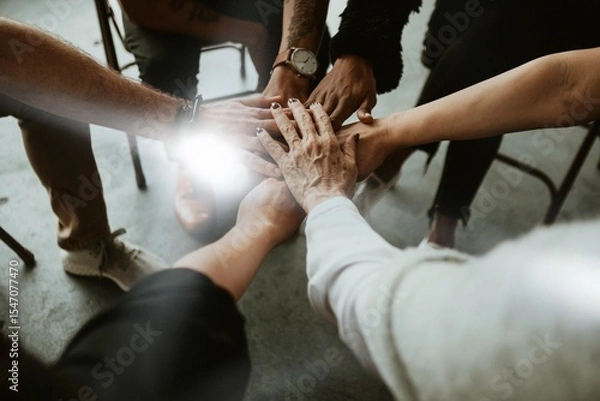 Fototapeta Group of diverse team joining hand in the middle