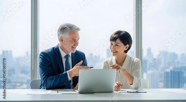 Obraz Focused Collaboration: Two professionals engaged in a focused collaboration at a modern office, the energy between them is palpable, the sunlight streams through the window.