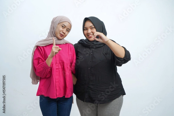 Obraz Happy Asian Indonesian Muslim Women Pointing Up and Smiling in Studio Portrait