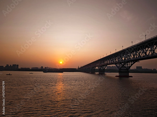 Fototapeta bridge and ship over the river at the sunset in Nanjing