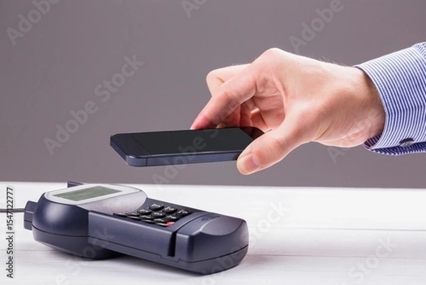 Obraz Man using smartphone to express pay