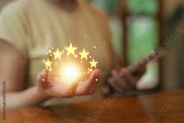 Fototapeta Asia woman using smartphone for select smiley face icon for client evaluation and customer satisfaction after use product and service concept...