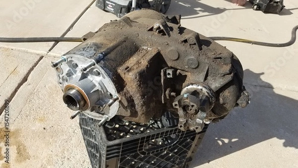Fototapeta Transfer Case from a 1980s 4x4 SUV Sits on a Driveway 